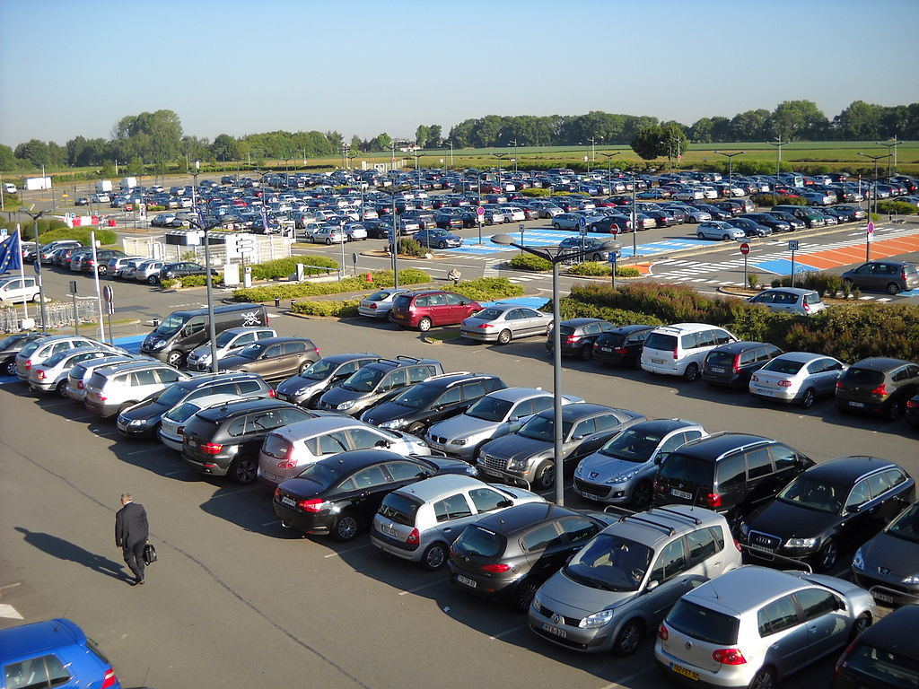 an airport carpark wih lots of parked cars. Click here for the page of booking airport parking deals.
